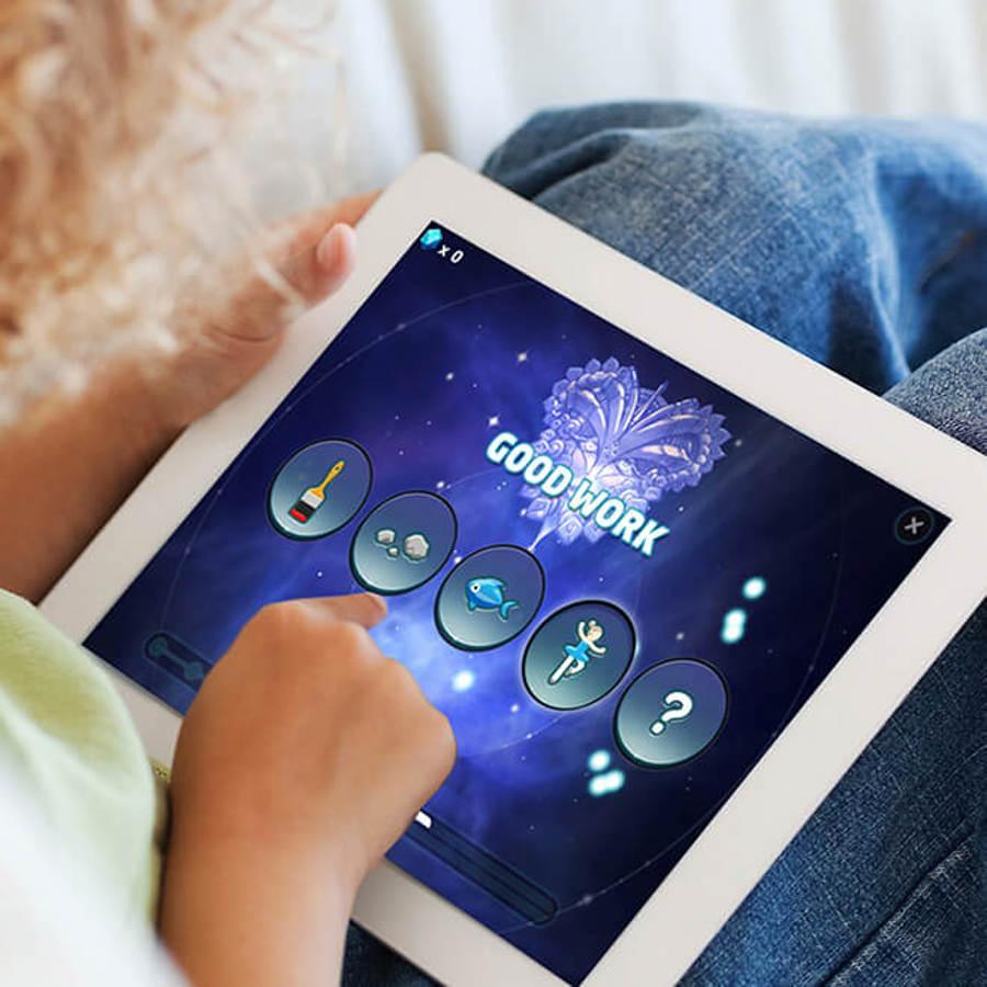 Child sitting on lounge playing Sound Storm on iPad
