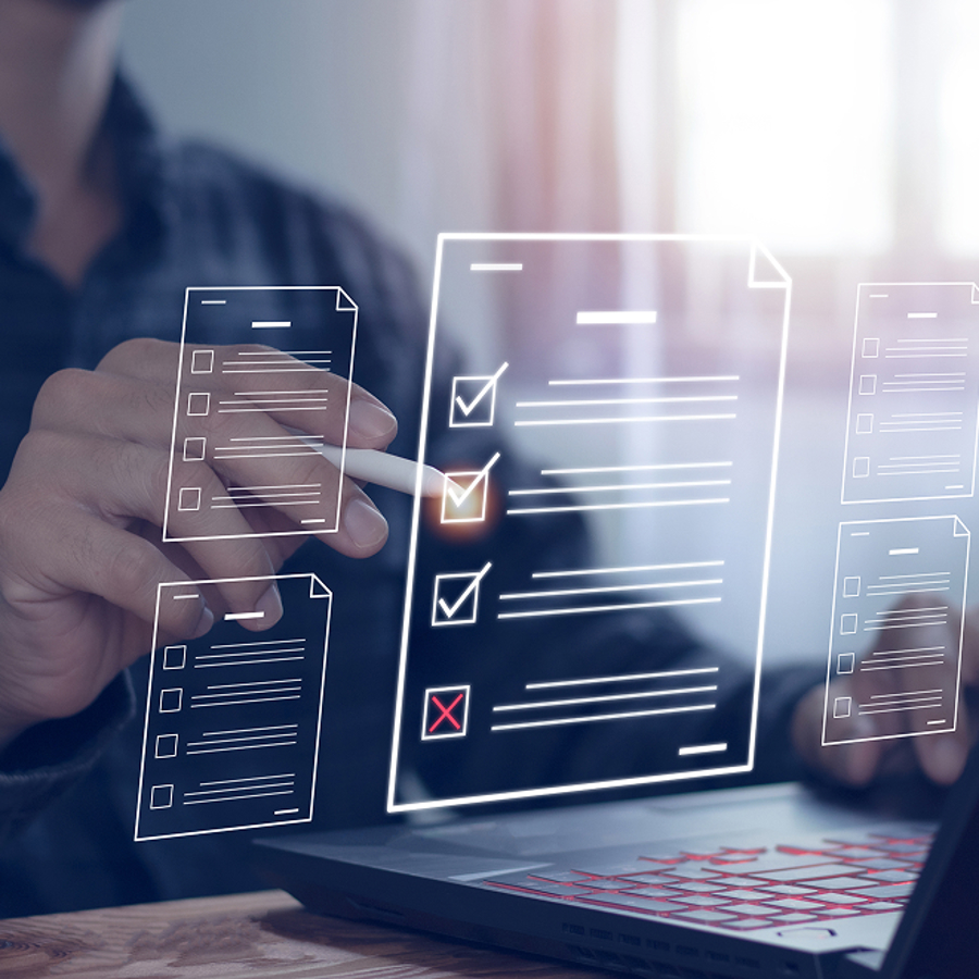 Stock image of person working on laptop testing and risk solutions