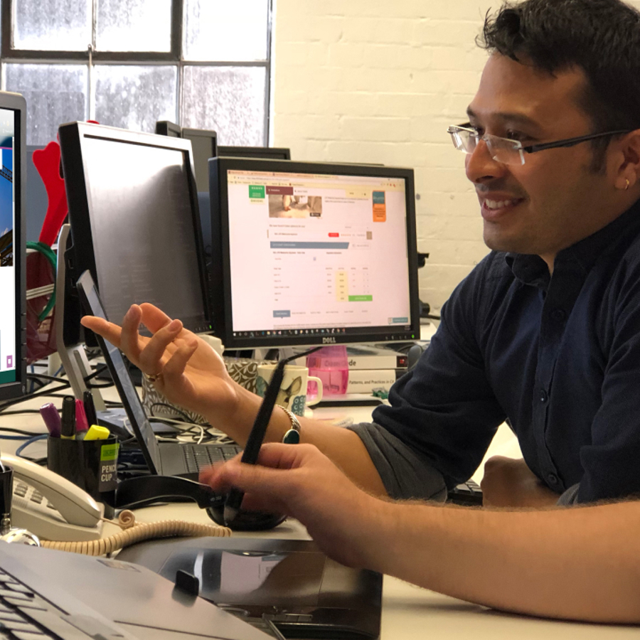 Two people at desk in office showing collaboration with the internal ABCB development team
