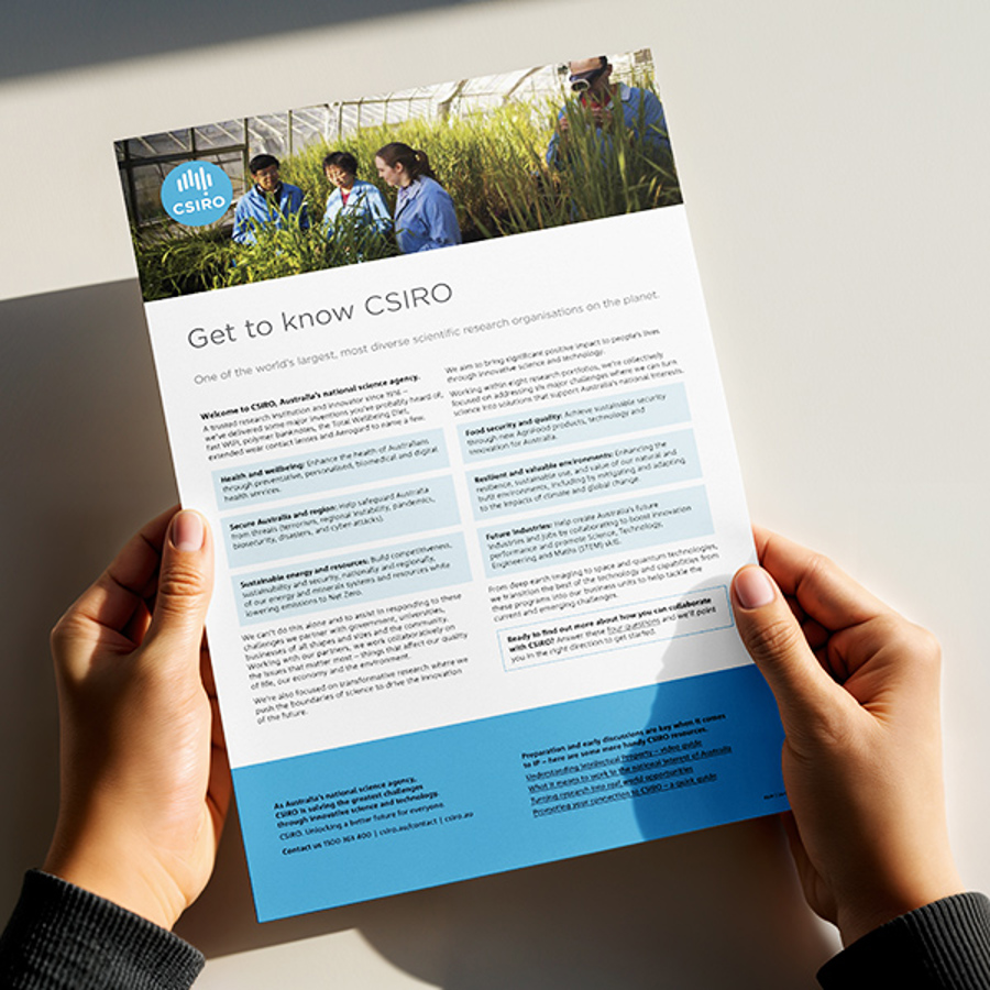 Hands holding CSIRO branded flyer