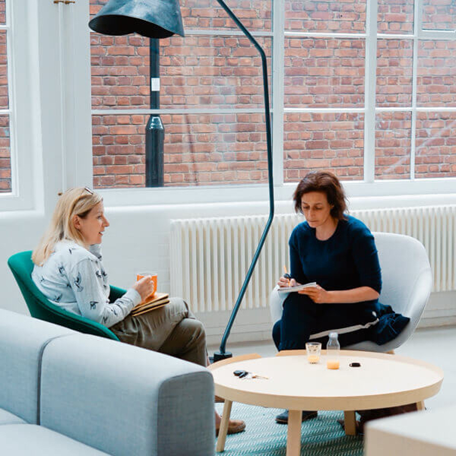 Two people sitting in office for interviews with key project stakeholders