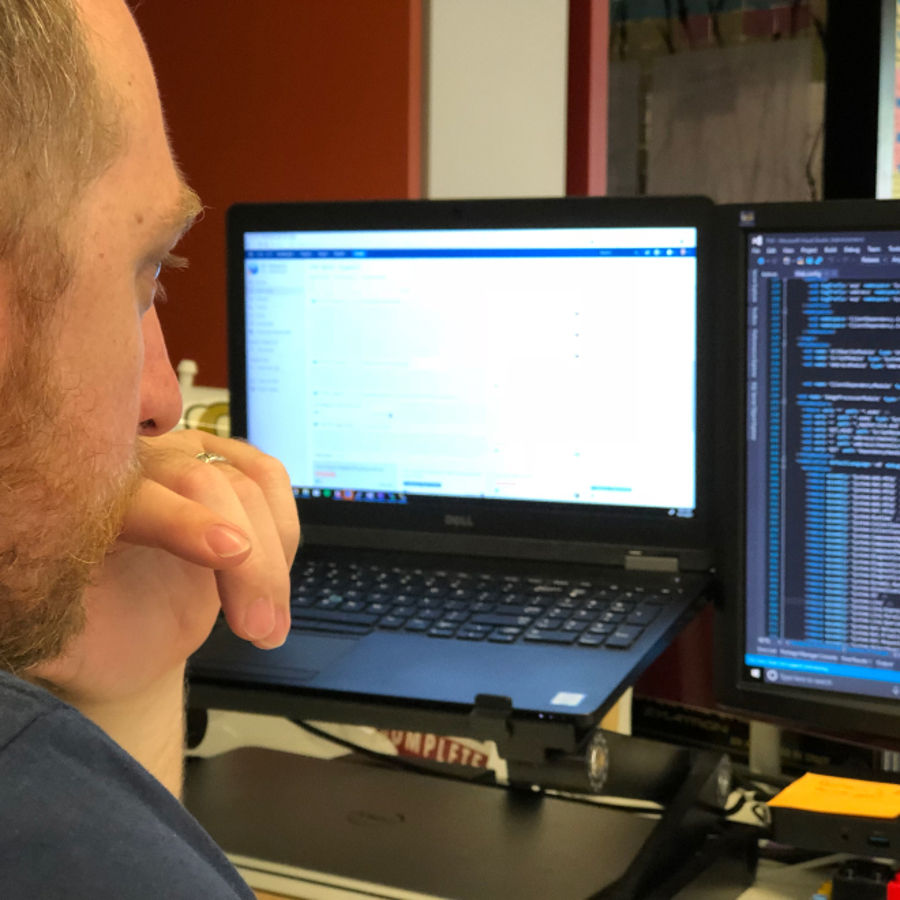 Person looking at laptop and screen showing different sub-divisions using Sub Themes 