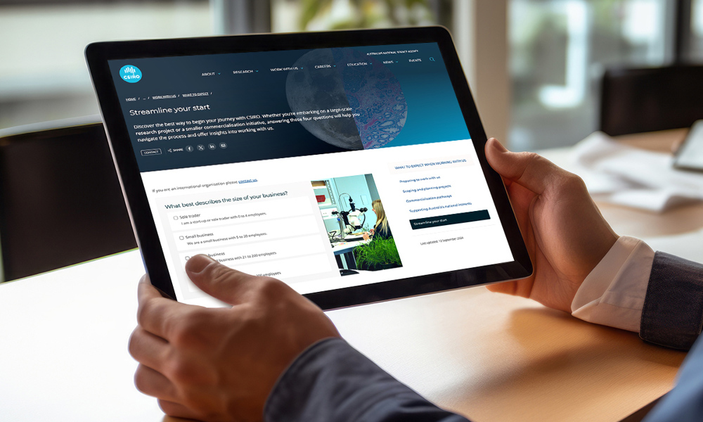Person holding tablet looking at CSIRO information