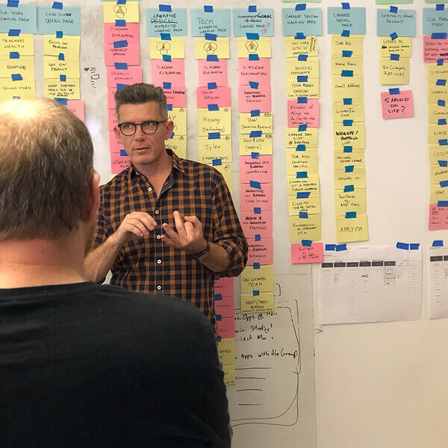 Photo of team showing two people with BioIsland roadmap